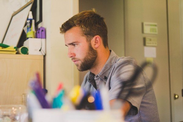 young-man-sitting-and-working-at-desk